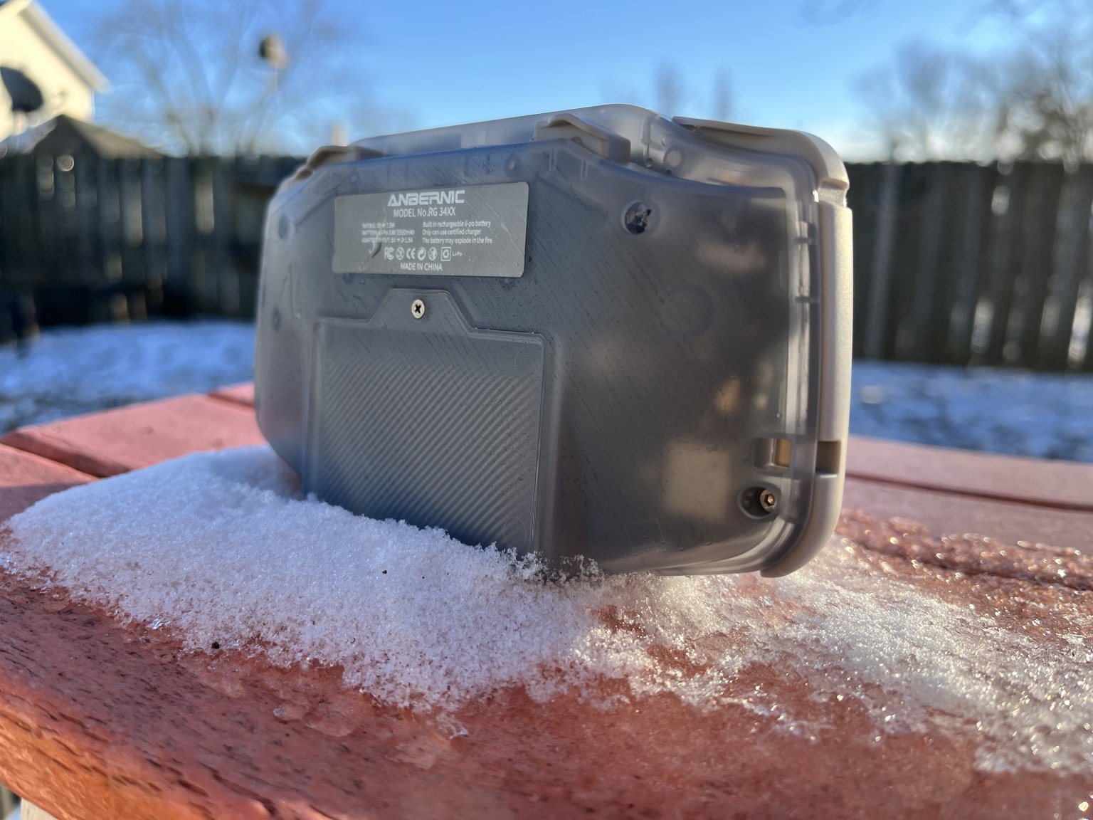 Anbernic RG34XX - Glacier - Propped up on snow - Retro Handhelds Anbernic RG34XX - Glacier - Propped up on snow