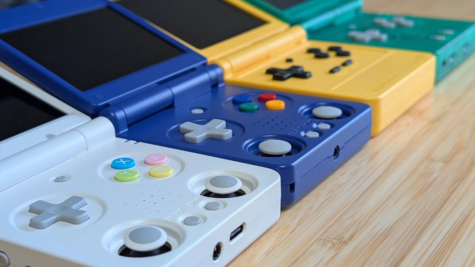 Anbernic RG34XX SP, RG35XX SP, Miyoo Flip, and Powkiddy V90S angled