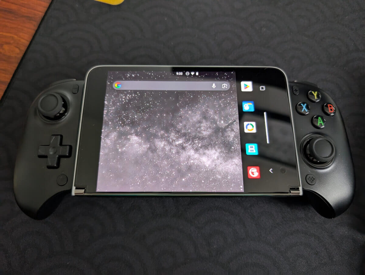 Surface Duo with the left screen folded underneath with an 8Bitdo Ultimate Mobile Gaming Controller